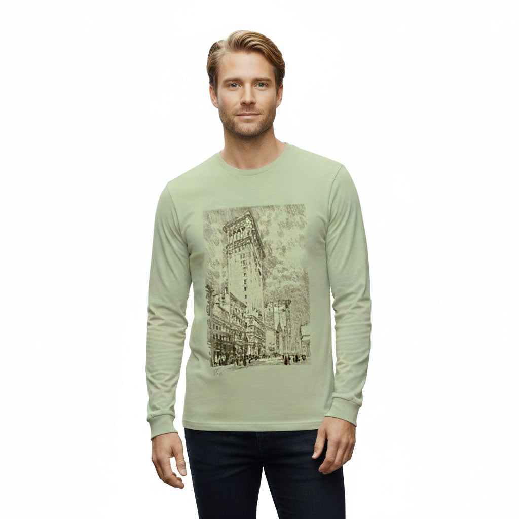 Man wearing a light green long-sleeve shirt with a graphic design on a white background